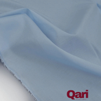 Soft light blue cotton fabric with gentle folds and frayed edge, ideal for sewing and crafting projects